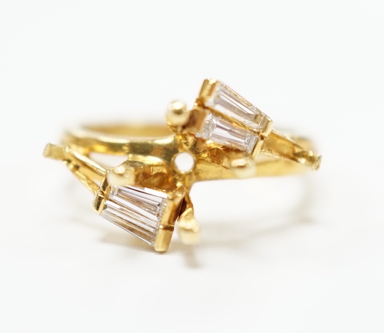 A modern 18ct gold and four stone trapeze cut diamond set crossover ring, size J, (central stone missing), size I/J, gross weight 4.6 grams.